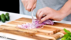 Chopping Red Onion on a Wood Board